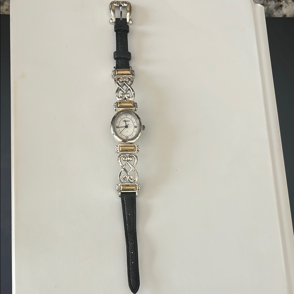 Elegant Black and Silver Watch with Gold Accents